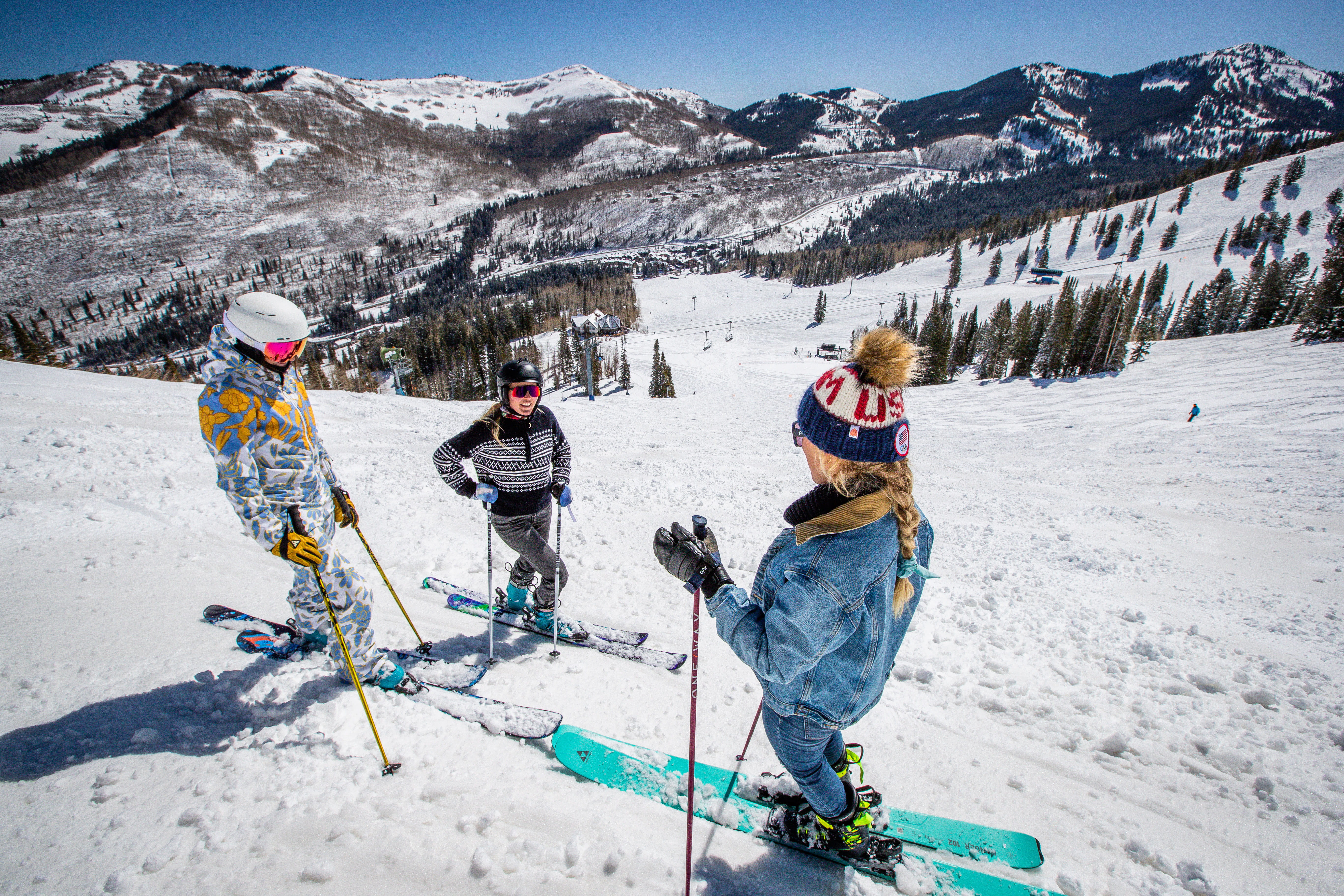 three skiers on a ski run