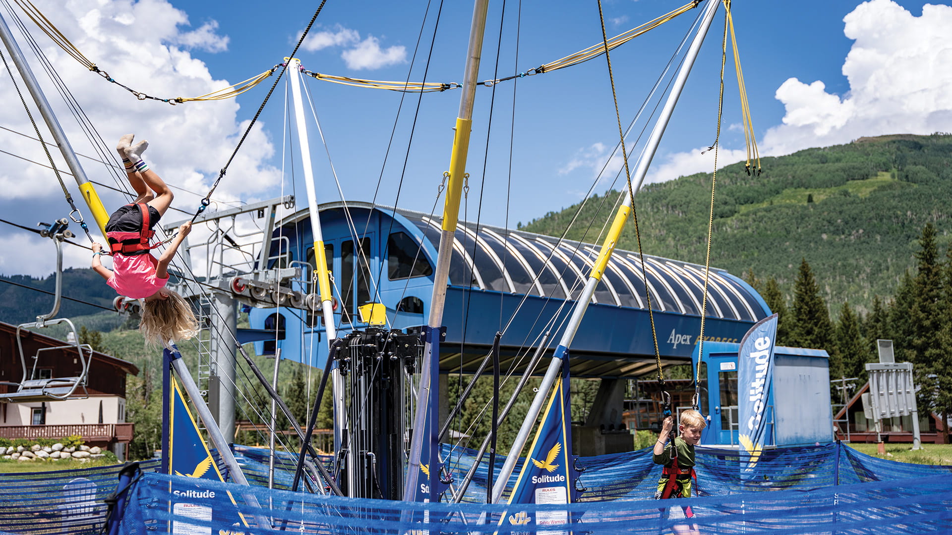 Kids flipping on the bungee trampoline at the Adventure Park at Solitude