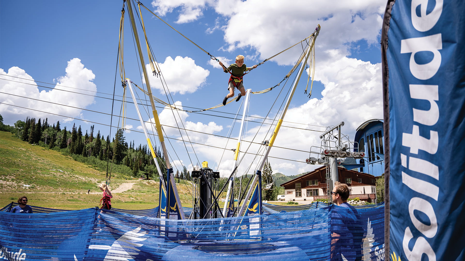 Child jumping on the bungee trampoline at the adventure park at Solitude