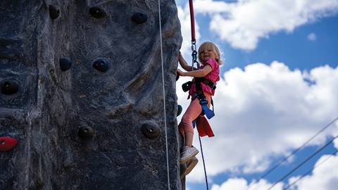 Kid climbing on rock wall at the Adventure Park at Solitude