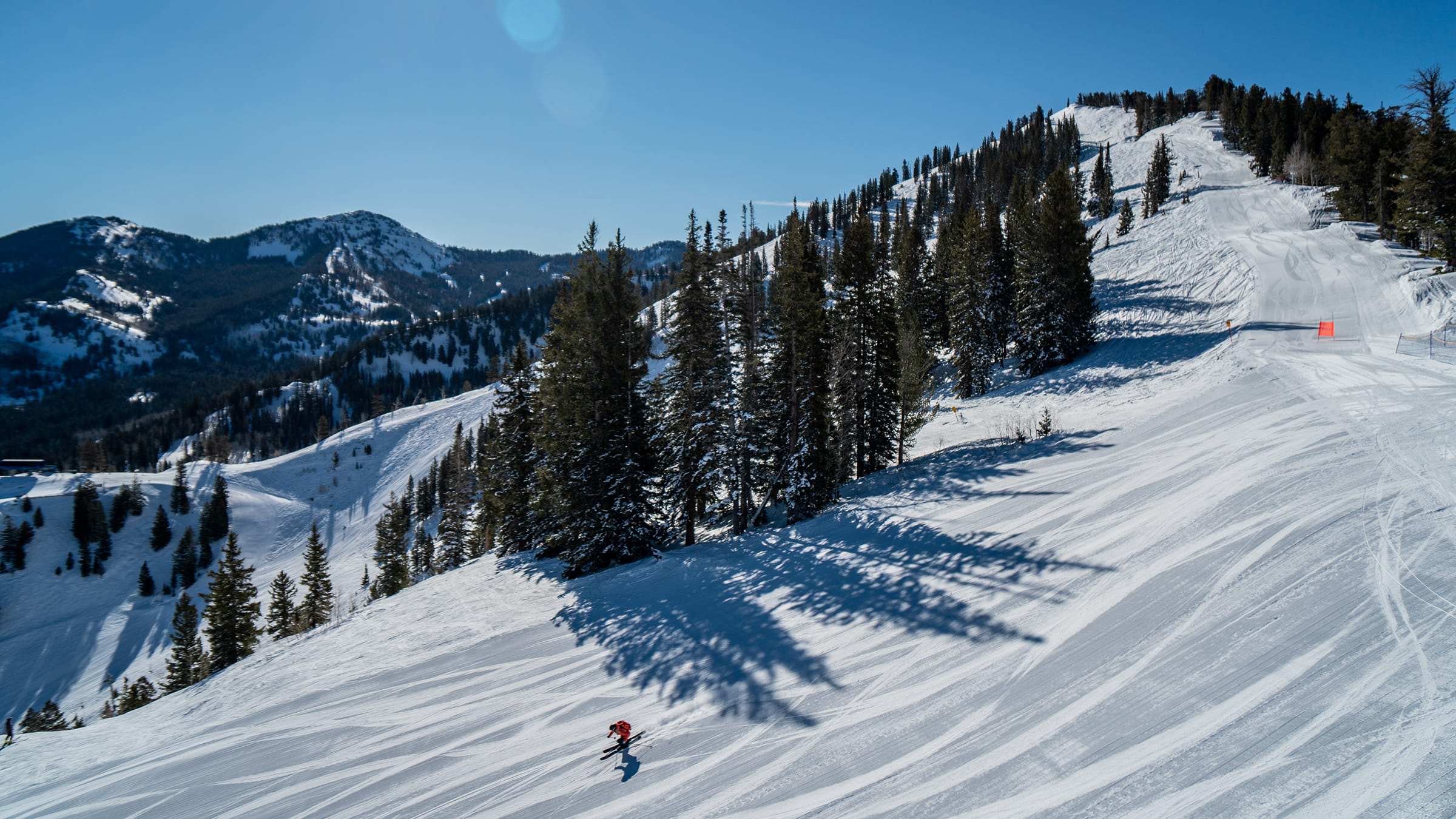 Skier enjoys a sunny groomer day off of Eagle Ridge