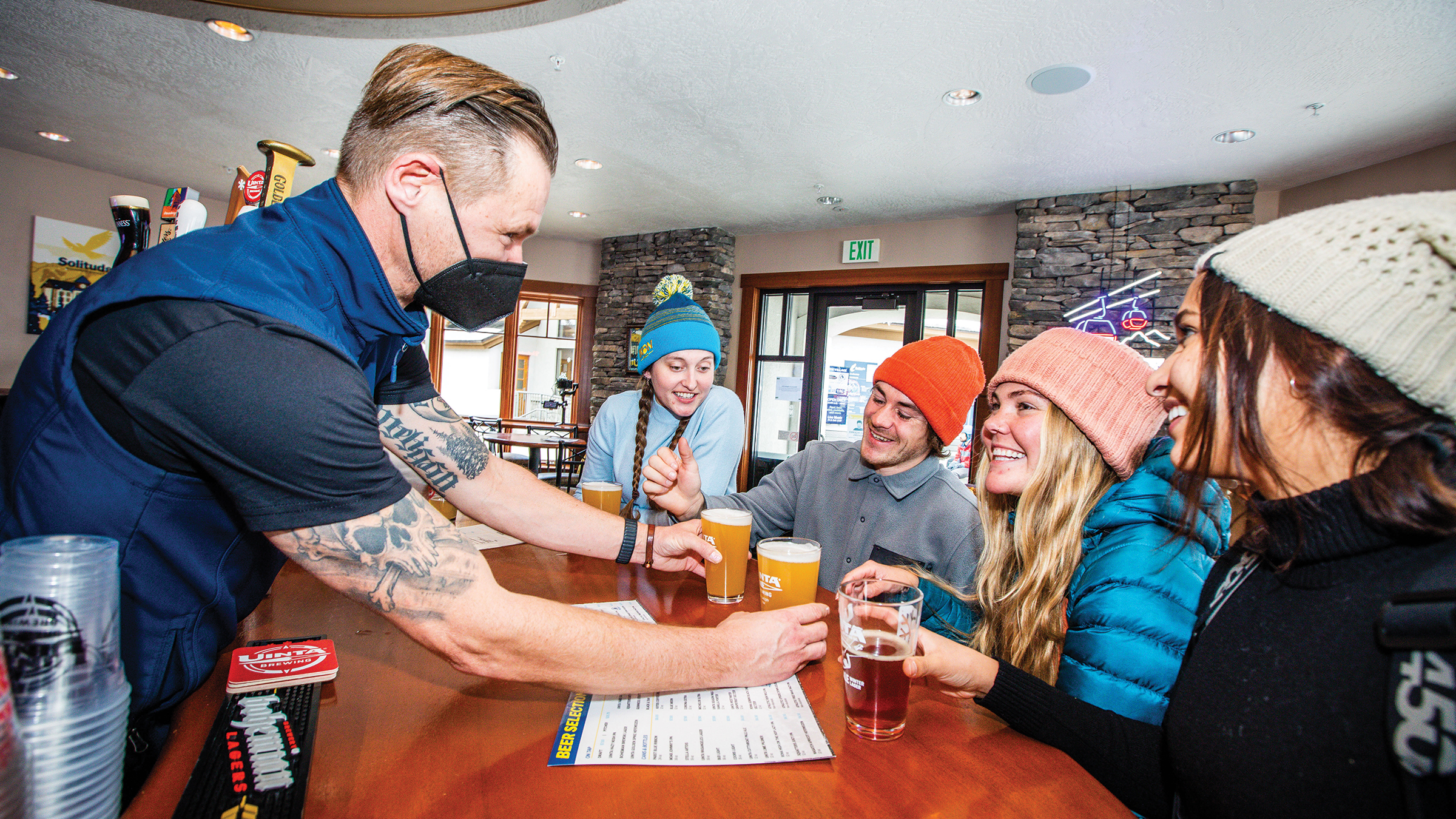 Bartender serving beers at Argenta Pub