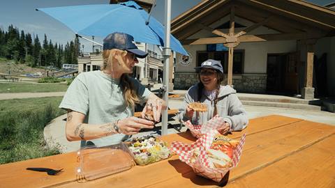 Two friends eating lunch at Little Dollie's