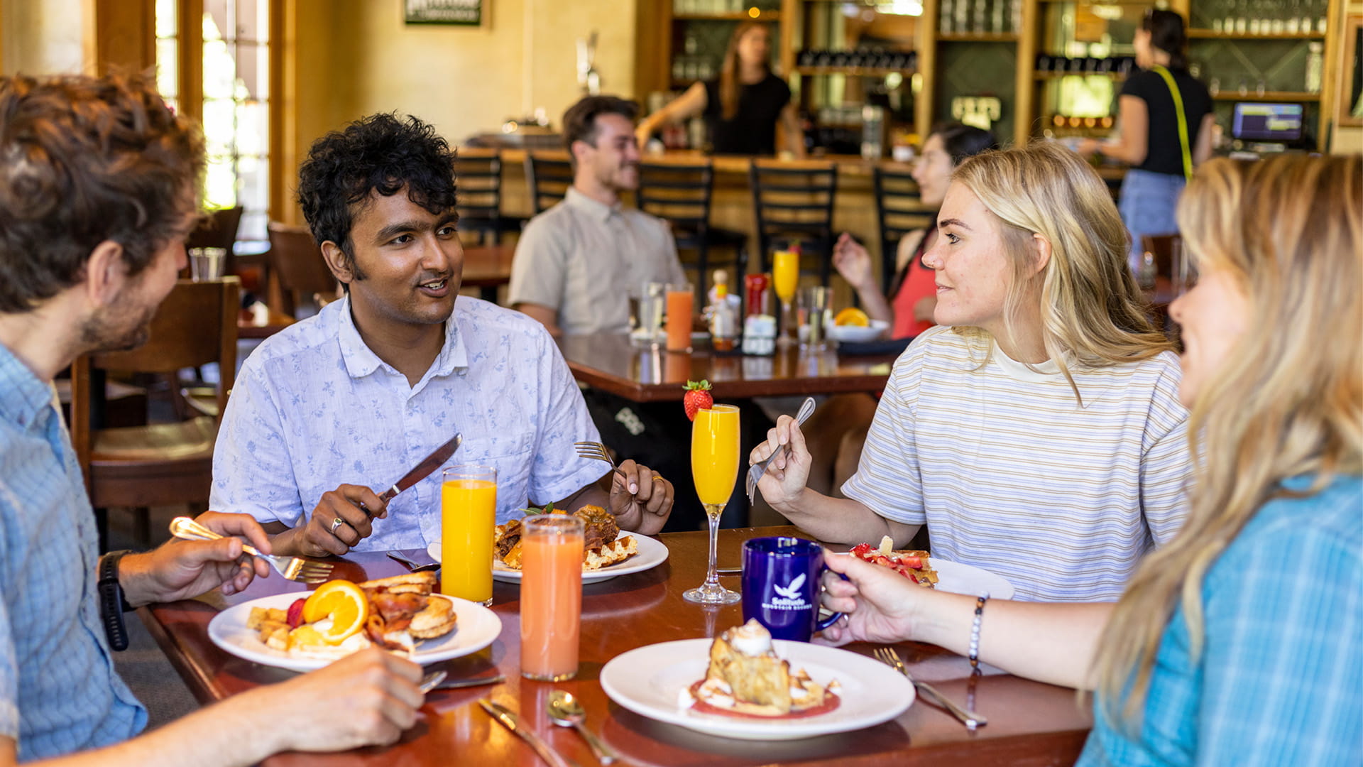 Friends talking over brunch at St. Bernard's at Solitude Mountain Resort