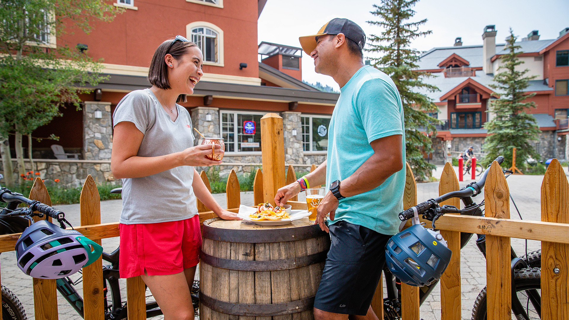 A couple enjoys drinks and nachos outside at The Thirsty Squirrel at Solitude Mountain Resort