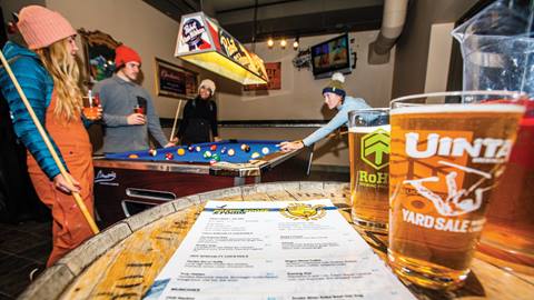 Friends playing pool at The Thirsty Squirrel