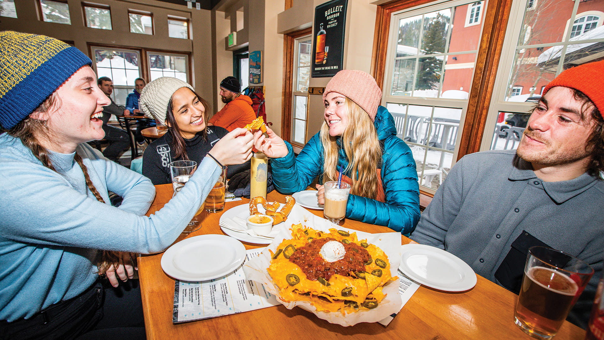 Friends eating nachos at The Thirsty Squirrel 