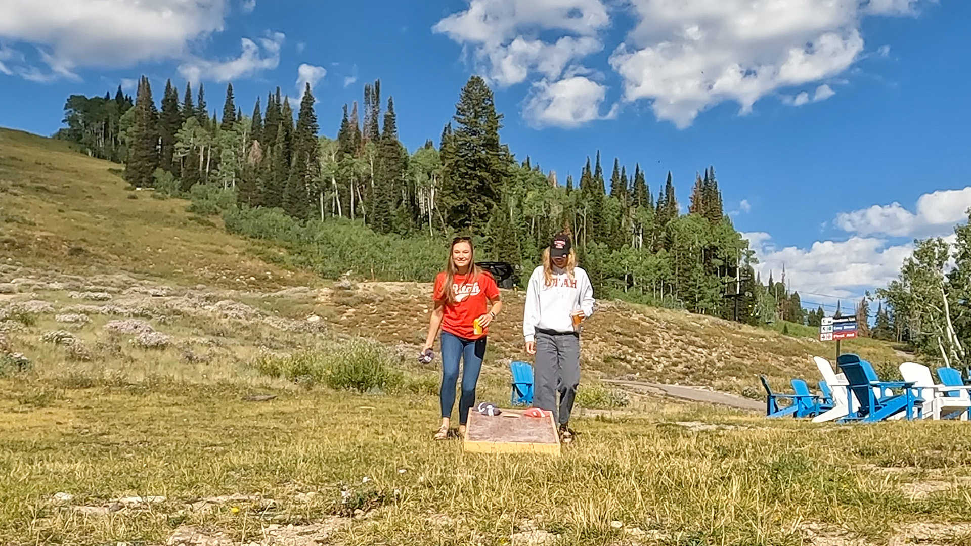 Two friends playing in a cornhole tournament at Solitude Mountain Resort
