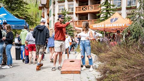 A couple playing cornhole at Big Cottonwood Brew Fest at Solitude Mountain Resort