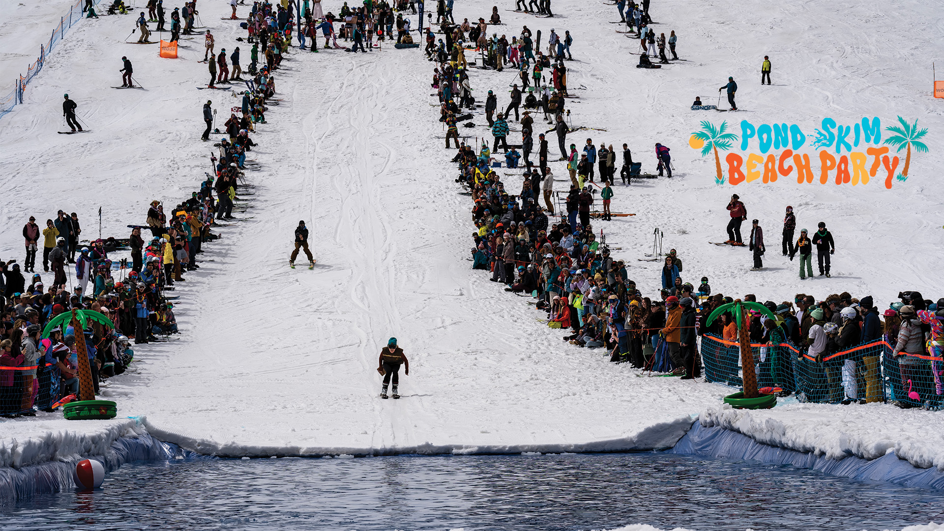 A skier about to ski across the pond at the Pond Skim at Solitude
