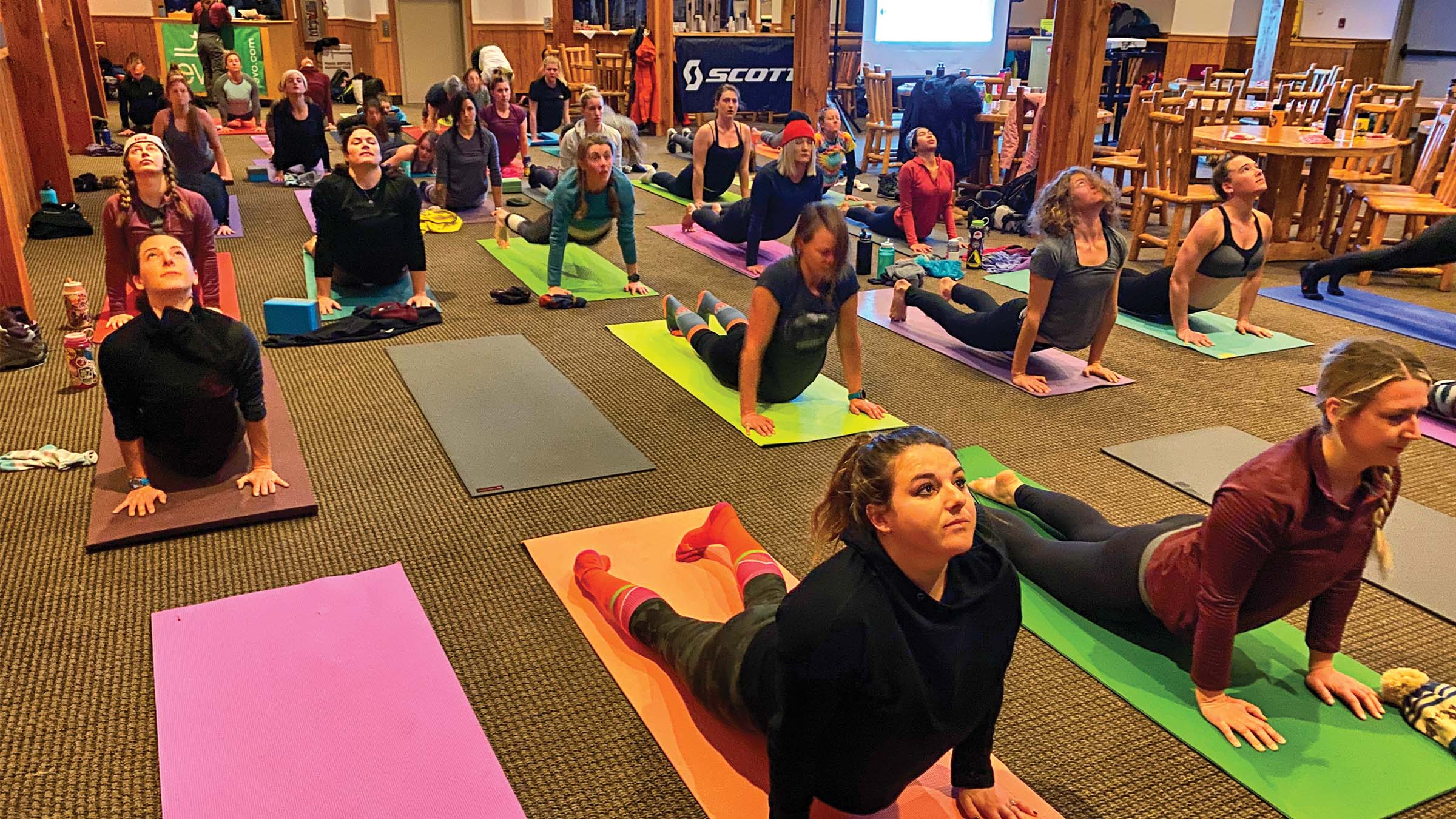 People partaking in Yoga inside Last Chance Lodge at Solitude