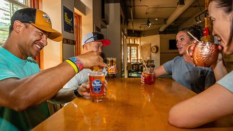 Friends enjoying drinks at The Thirsty Squirrel at Solitude Mountain Resort