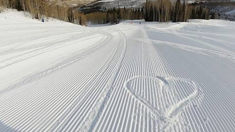 Heart in the snow on a Groomer