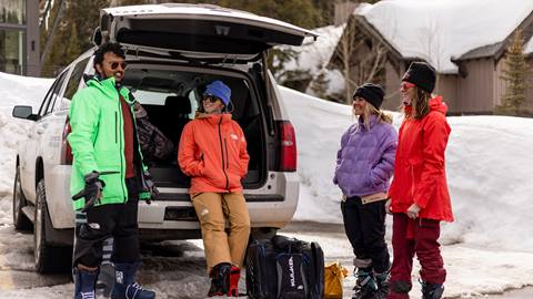 Four friends getting ready to ski after carpooling to Solitude Mountain Resort