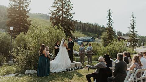 outdoor wedding ceremony with guests seated on a grassy lawn at a wedding venue at solitude mountain resort