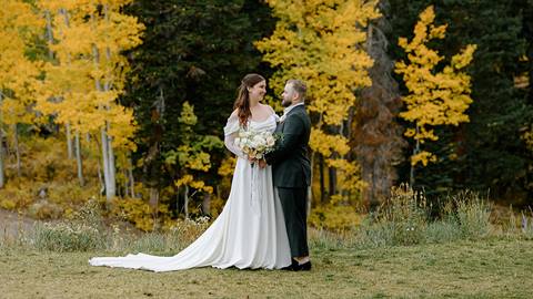 A bride and groom celebrate their wedding with fall colors at Solitude Mountain Resort