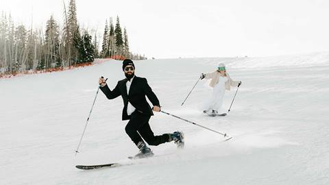 Wedding couple skiing at a winter wedding at Solitude Mountain Resort
