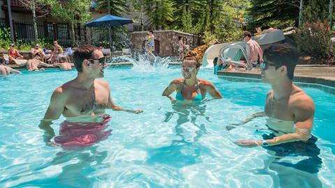 Three friends standing in the pool at Club Solitude