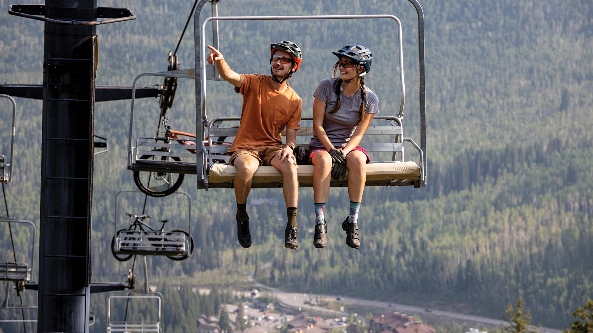Friends taking the lift up to mountain bike down