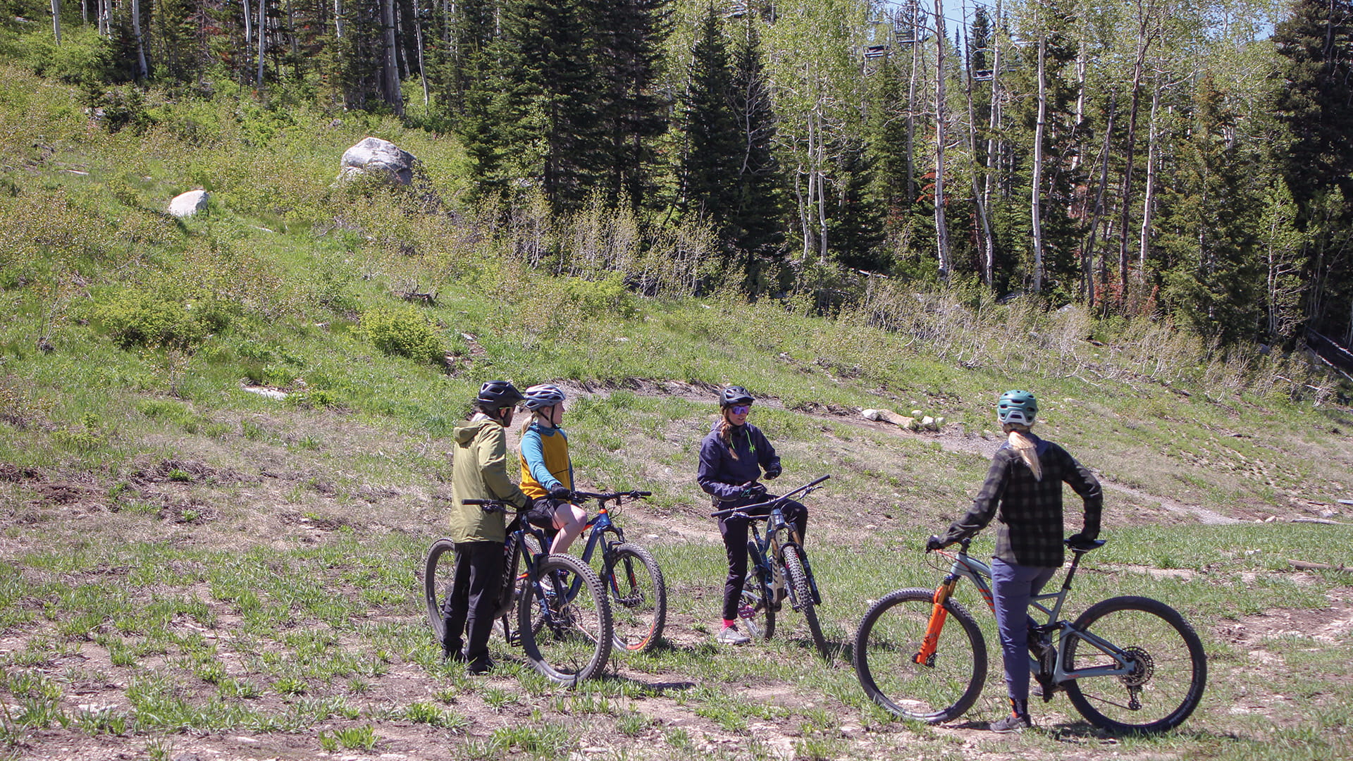 mountain bike lesson goers talking it through before hitting the bike trails