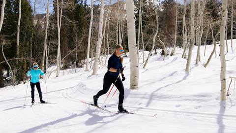 Two friends cross country skiing at the Solitude Nordic Center