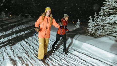 Two friends cross country skiing at Solitude Nordic Nights