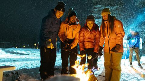 Four friends making smores at Solitude Nordic Nights