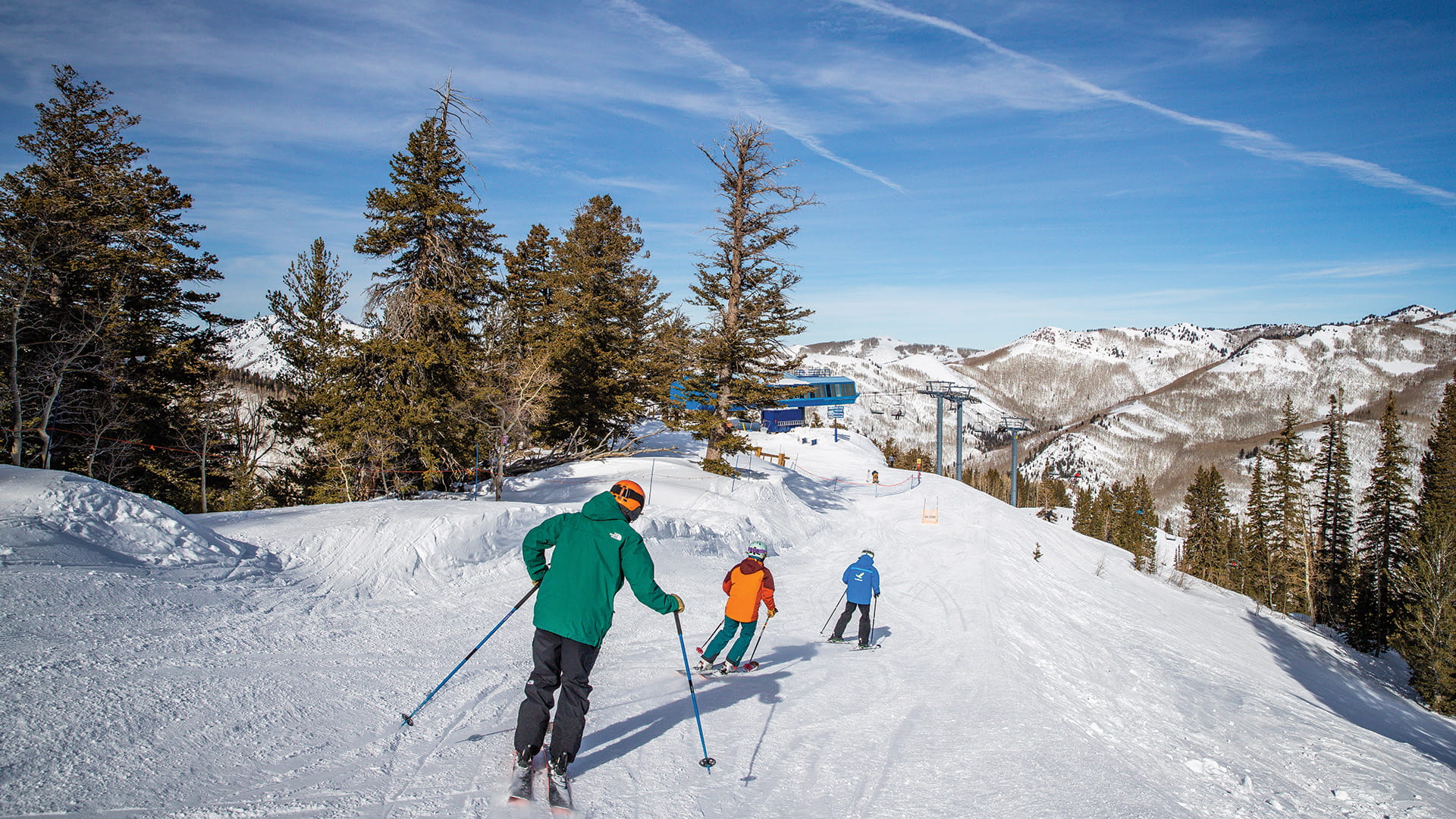 Two adults in group lesson following instructor down trail at Solitude