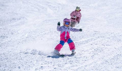 Mother and daughter skiing an empty trail at Solitude Resort in Utah