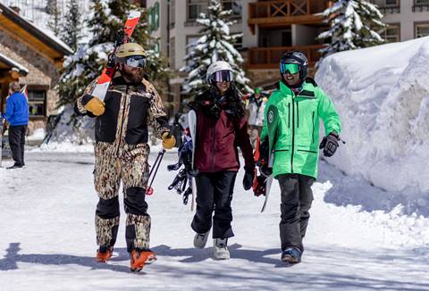 Group of friends walking through base village at Solitude Mountain  