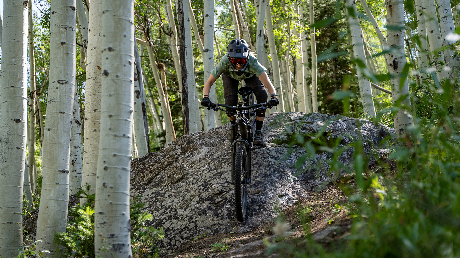 A biker riding a tech section on Holy Schist at Solitude Bike Park