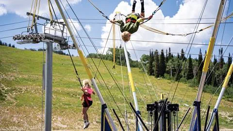 Two kids jumping on trampoline at Solitude Mountain Resort