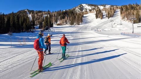 uphill skiers at sunrise lift 