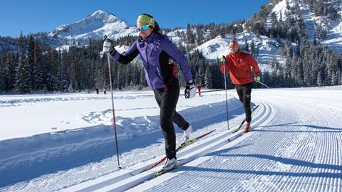 Two Nordic skiers on the Nordic Center track