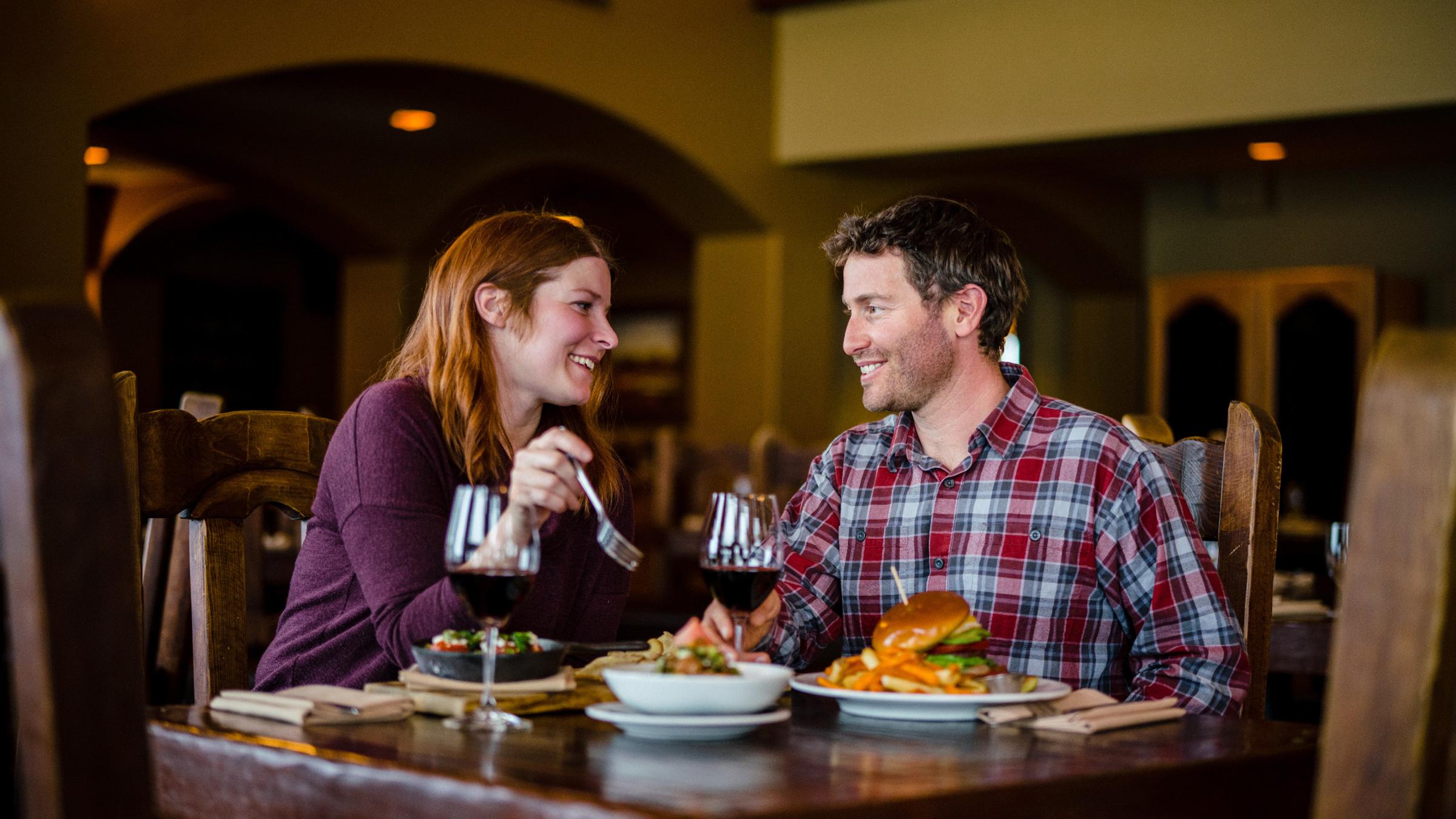 A couple enjoying dinner drinks at Honeycomb Grill at Solitude Mountain Resort