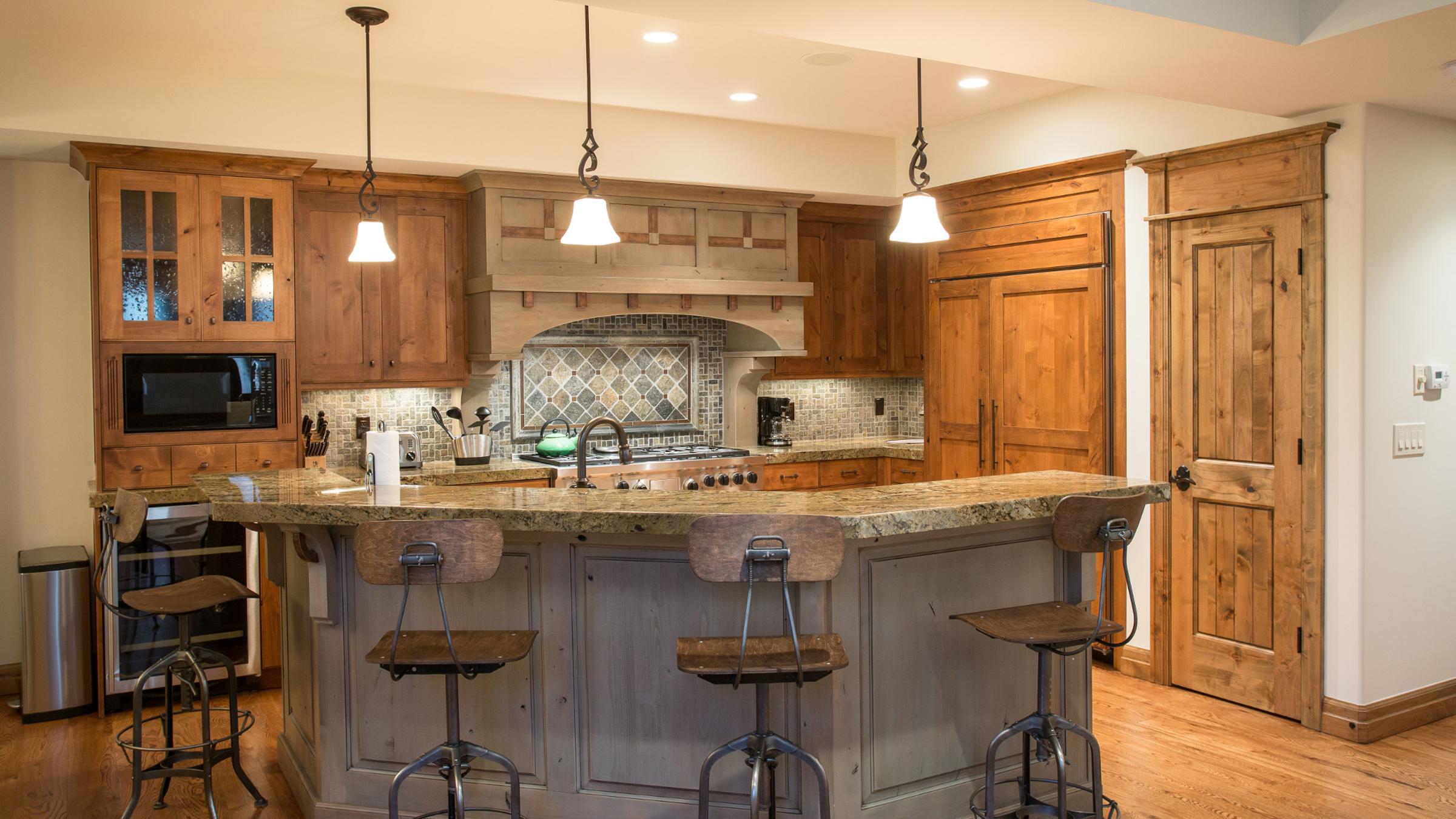 Full kitchen with appliances and bar seats