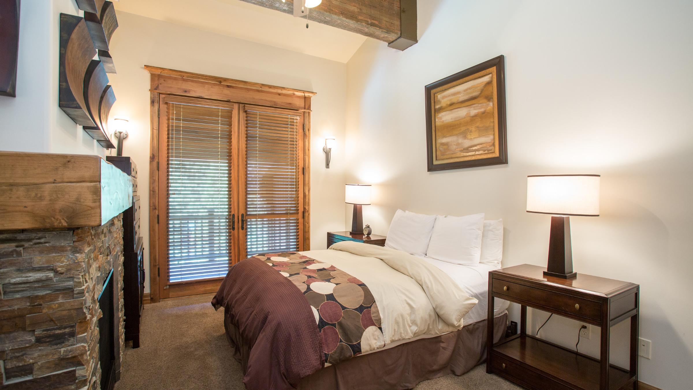 Bed with fireplace and balcony