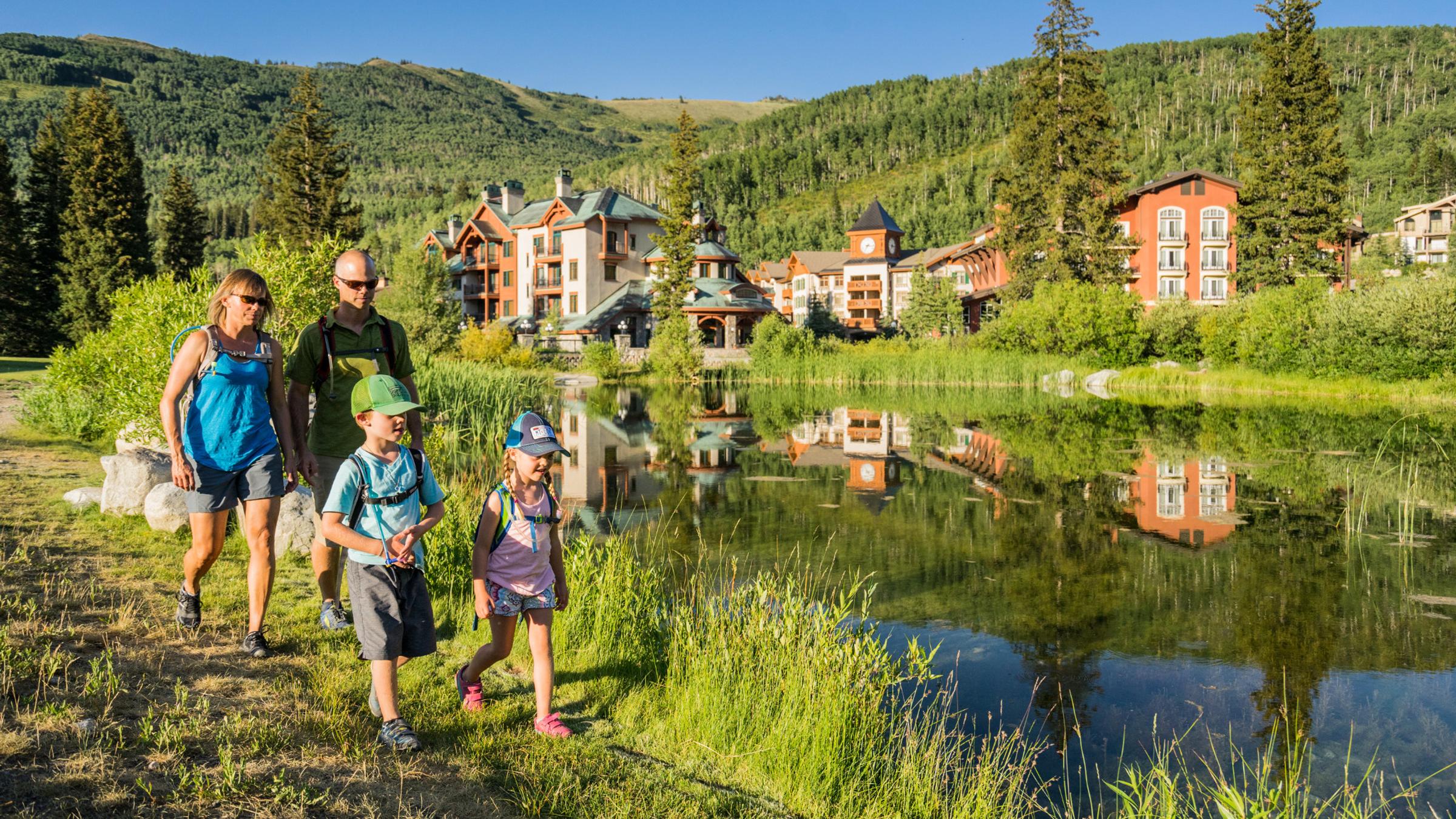 A family hiking around the village pond 