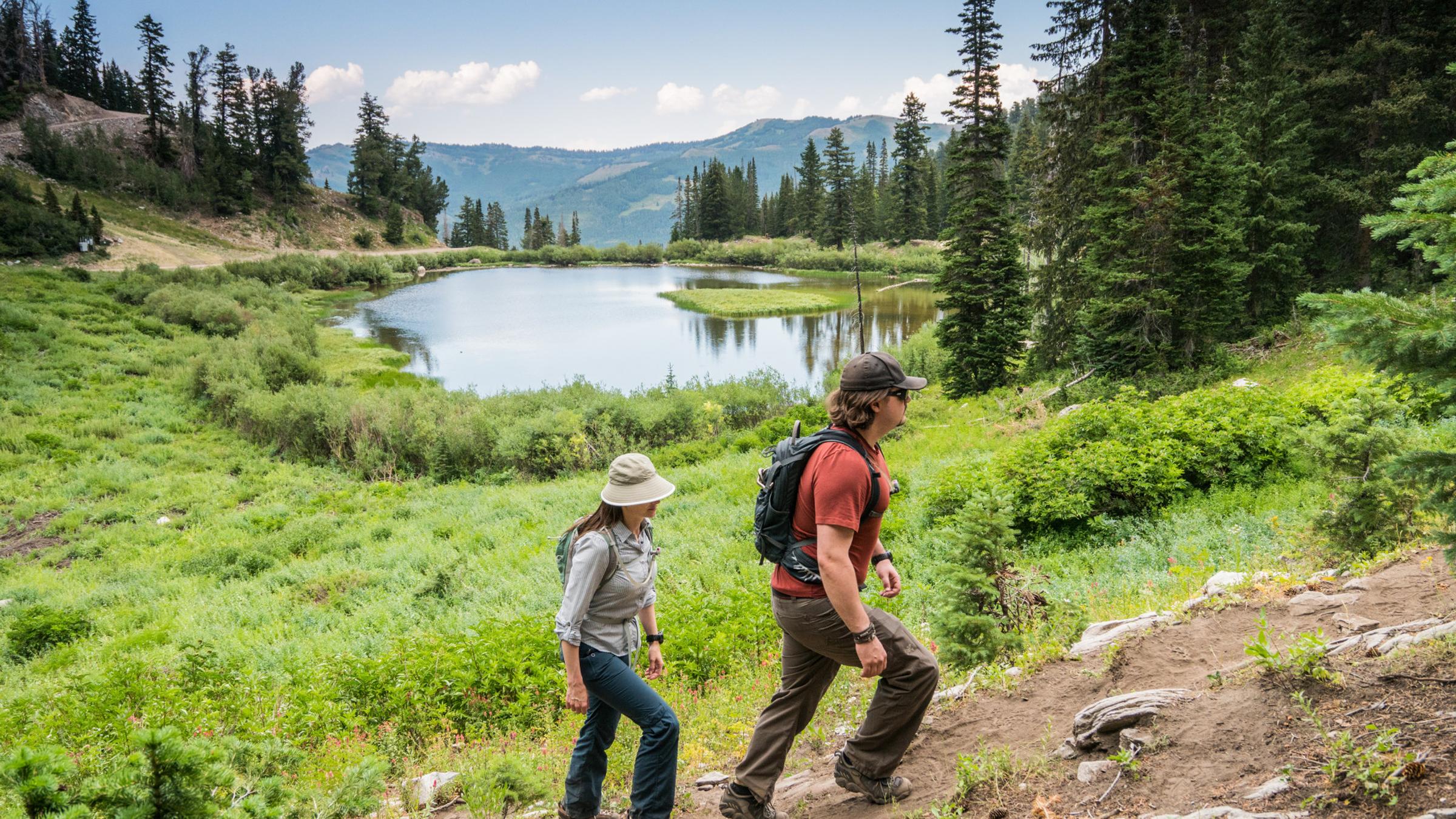 A couple hiking on the Solitude Lake trail with the lake in the background