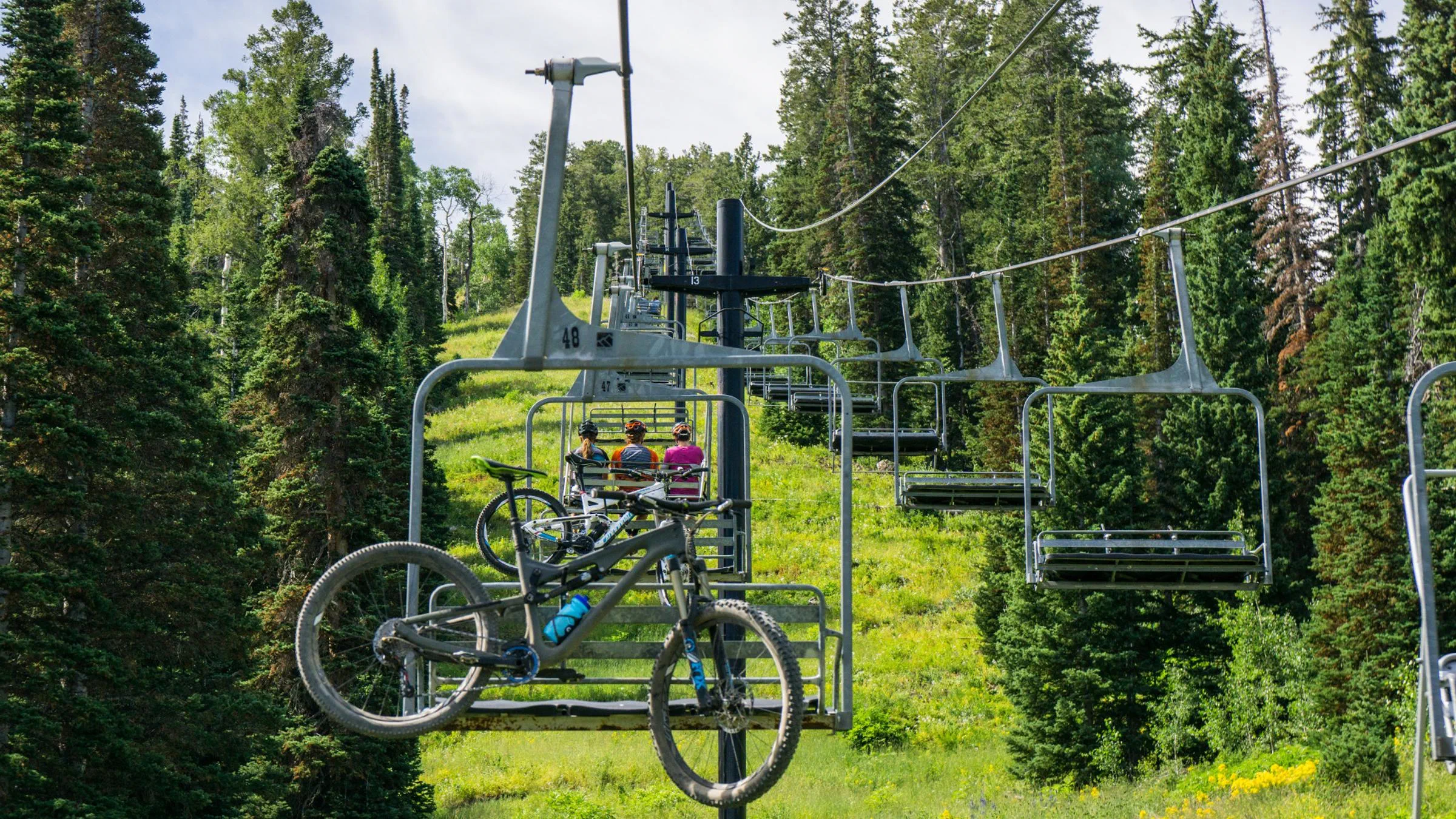 A mountain bike mounted to the chairlift for lit-served service