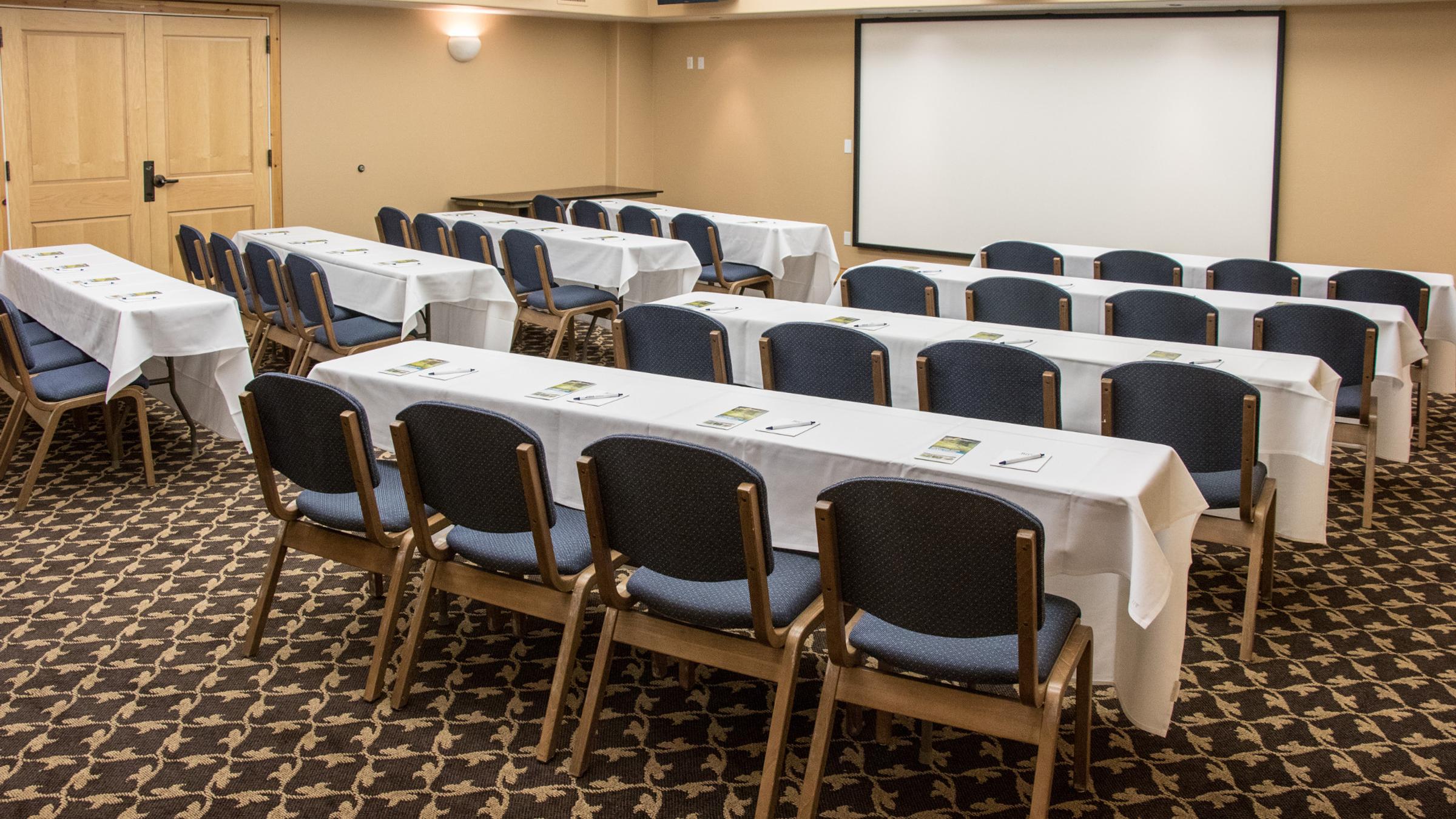 Meeting room in The Inn setup with rows of tables and chairs