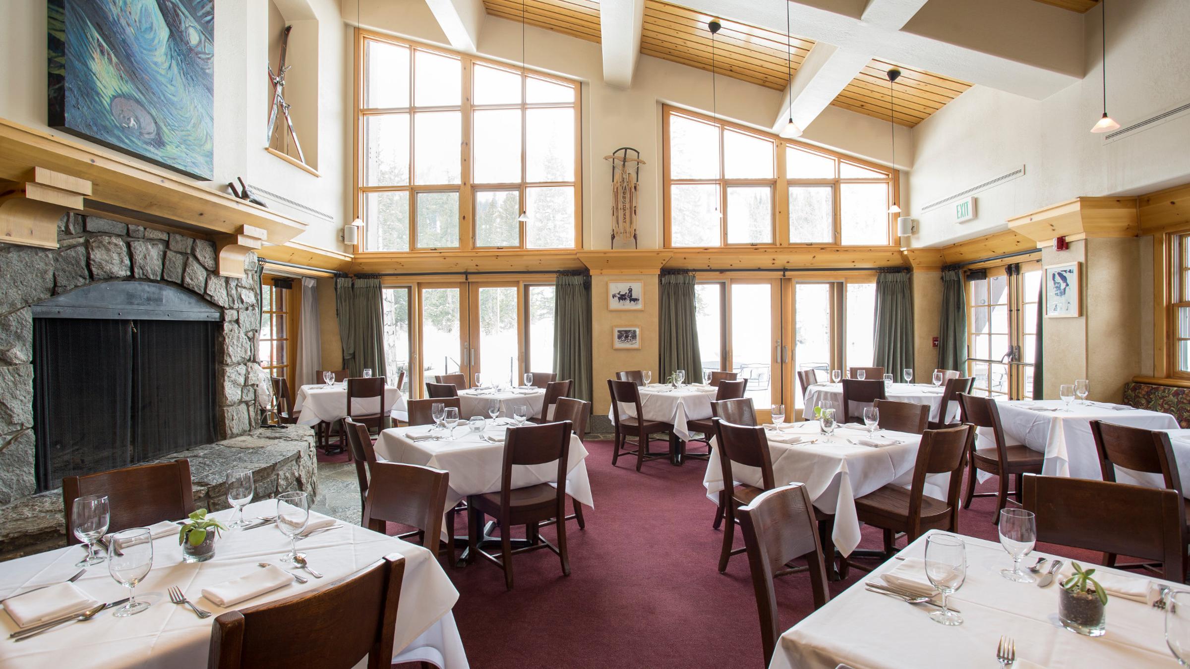 St. Bernard's meeting space setup with square tables and chairs