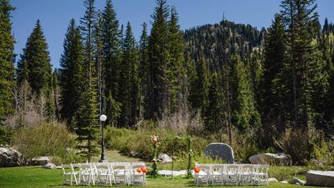 outdoor ceremony seating set among pine trees and mountain scenery at a wedding venue at solitude mountain resort