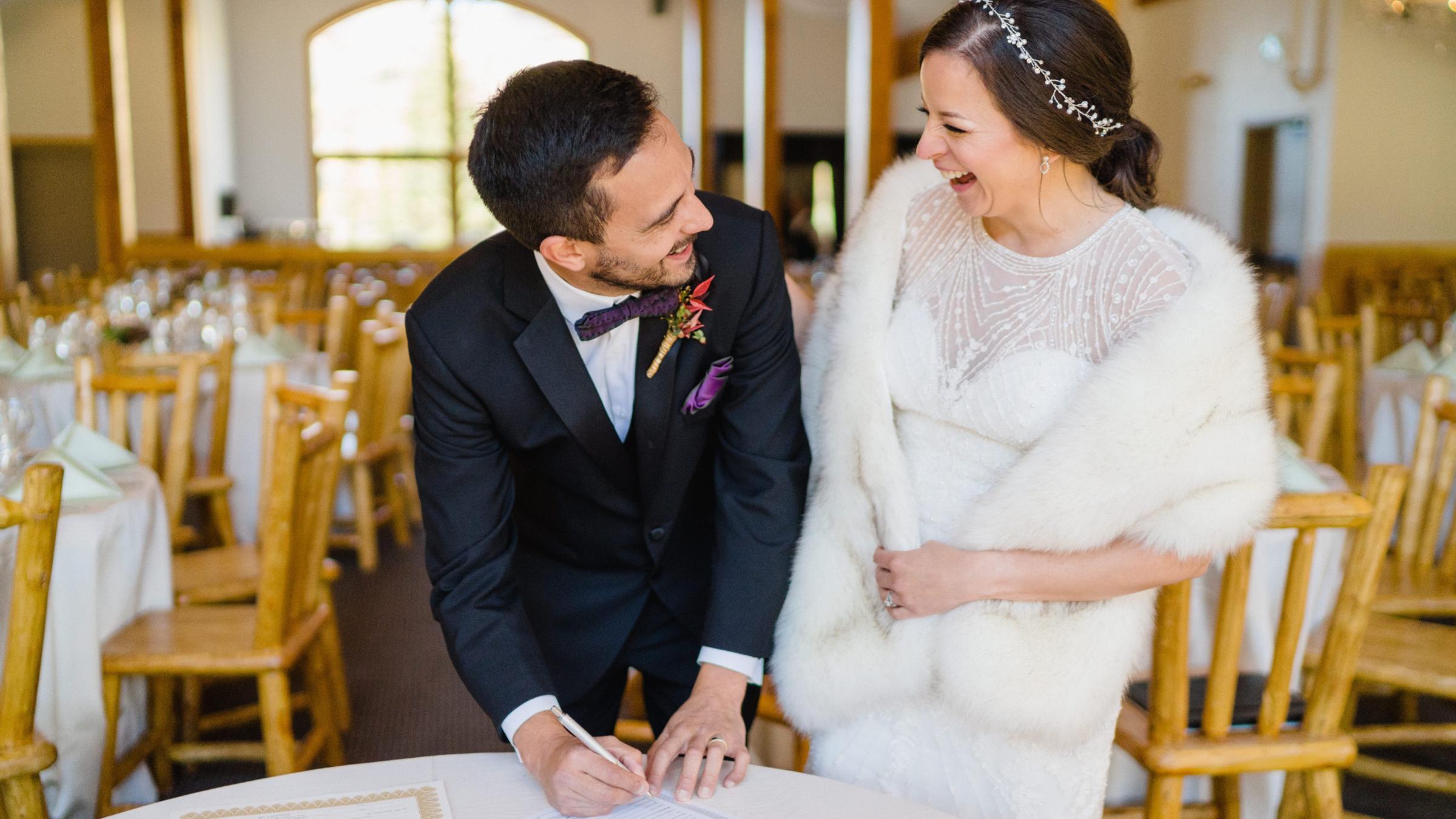 Bride and Groom Signing Marriage Certificate