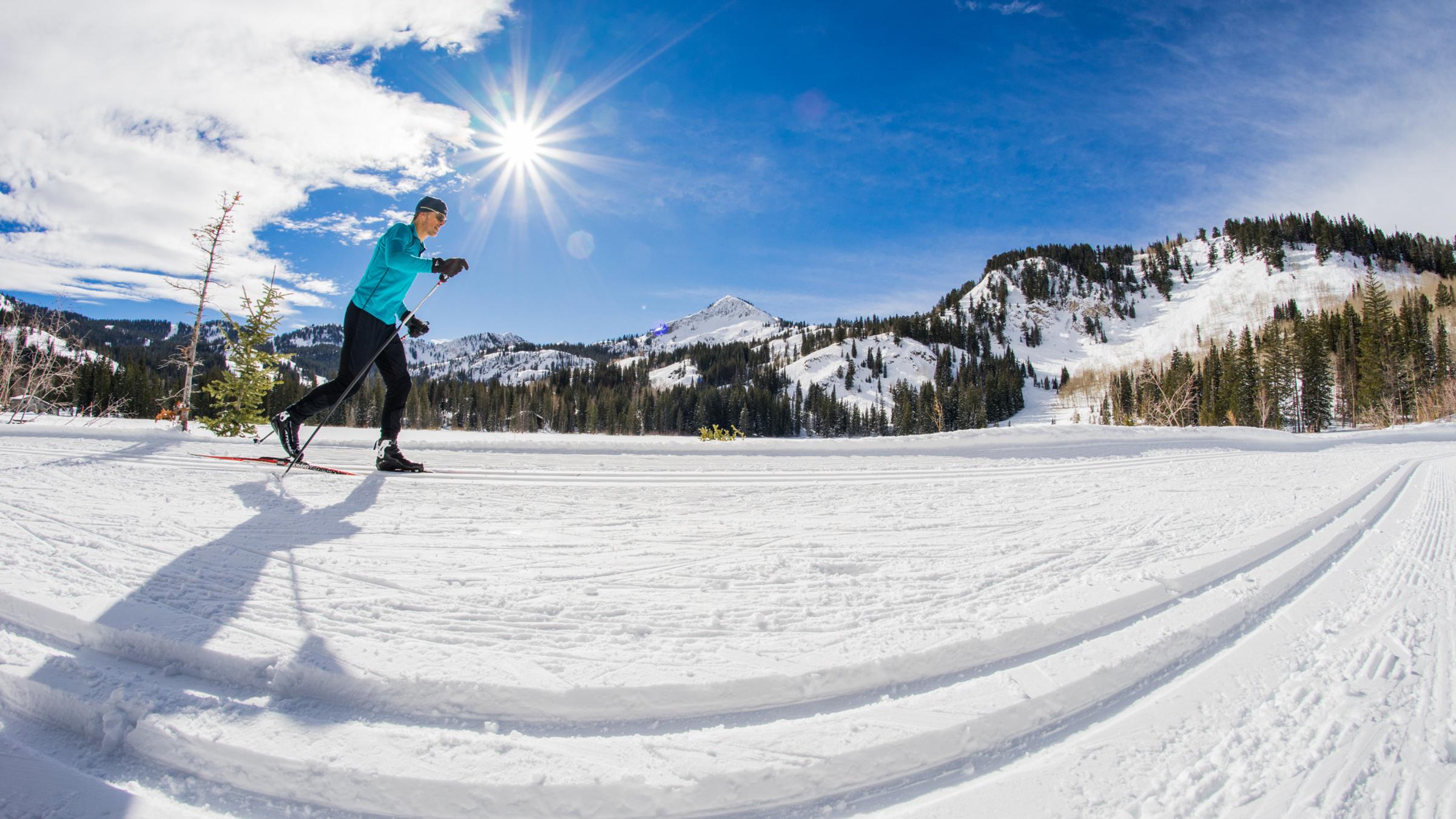 A man Nordic skiing on groomed trails