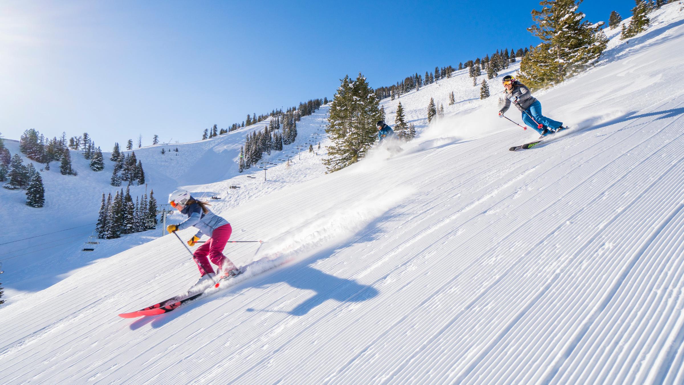 Two skiers on Diamond Lane Groomer