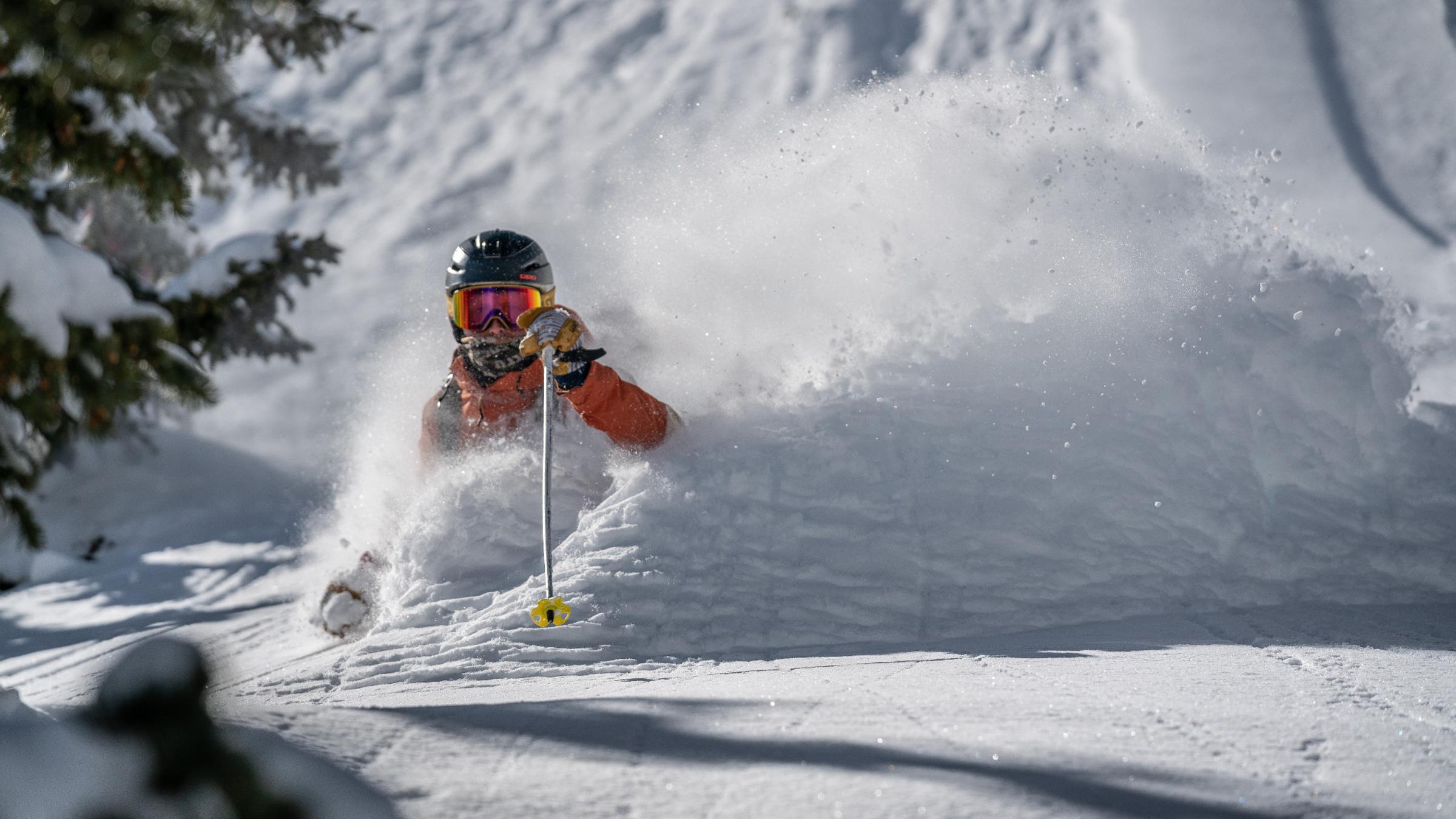 A skier skiing in waist deep powder 