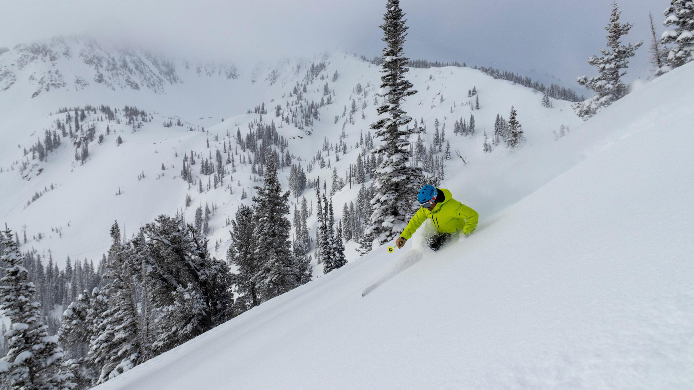 Skier takes a turn in powder on Highway to Heaven at Solitude Mountain Resort