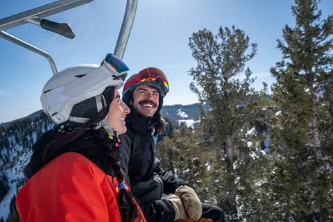 Male and female skier on chairlift